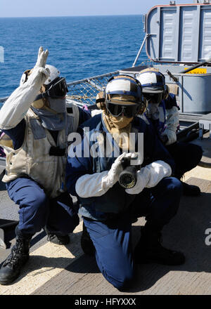 110715-N-KB052-563  TIMOR SEA (July 15, 2011) Boatswain’s Mate 3rd Class John King, leader of hose team three, communicates with the on-scene leader during a crash and salvage drill aboard the Ticonderoga-class guided-missile cruiser USS Cowpens (CG 63). Cowpens is forward deployed to Yokosuka, Japan, and is underway in the U.S. 7th Fleet area of responsibility. (U.S. Navy photo by Mass Communication Specialist 1st Class N. Ross Taylor/Released) US Navy 110715-N-KB052-563 Boatswain's Mate 3rd Class John King, leader of hose team three, communicates with the on-scene leader during a crash a Stock Photo