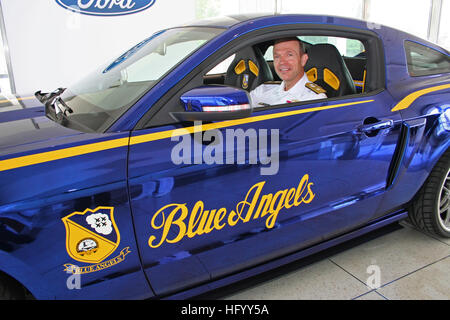 110720-N-ZL585-274 DEARBORN, Mich. (July 20, 2011) Rear Adm. John E. Jolliffe, vice commander of U.S. Naval Forces Central Command, sits behind the wheel of the Navy Blue Angels Ford Mustang. The car will be auctioned off at the ESL International Air Show to raise funds for student aviation scholarships. Jolliffe and Sailors from local commands visited the Ford Motor Company corporate headquarters during Detroit Navy Week 2011, one of 21 Navy Weeks being held this year across the country. Navy Weeks are intended to showcase the investment Americans have made in their and increase awareness in  Stock Photo