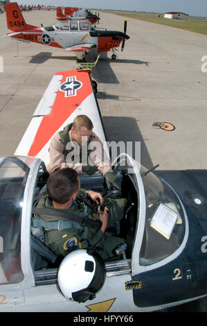 110720-N-LY958-098  CORPUS CHRISTI, Texas (July 20, 2011) Instructor pilot Lt. Cmdr. Daniel Kelly and student naval aviator Ensign Christopher Tucker, both assigned to Training Squadron (VT) 28, discuss the flight instruments in the T-34 Turbomentor aircraft before a training flight. VT-28 is one of two primary squadrons based at Naval Air Station Corpus Christi that train naval aviators. (U.S. Navy photo by Richard Stewart/Released) US Navy 110720-N-LY958-098 Instructor pilot Lt. Cmdr. Daniel Kelly and student naval aviator Ensign Christopher Tucker, both assigned to Training S Stock Photo