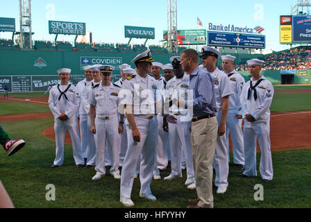110727-N-AW342-177 BOSTON (July 27, 2011) Cmdr. John McGunnigle, commanding officer of the fast attack submarine USS New Hampshire (SSN 778), presents Sam Kennedy, executive vice president and chief operating officer of the Boston Red Sox, the New Hampshire flag to fly over the park during the game. The flag was also flown on the New Hampshire in the Artic during Ice Exercise 2011. (U.S. Navy photo/Released) US Navy 110727-N-AW342-177 Cmdr. John McGunnigle presents Sam Kennedy the New Hampshire flag to fly over the park during the game Stock Photo