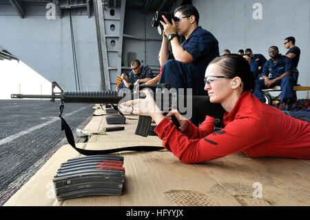 Reagan Rigle Aviation Ordnanceman fires an M-16A2 assault rifle during a small arms ...