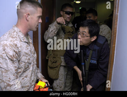 110822-N-UU879-071  SINGAPORE (Aug. 22, 2011) Capt. Brett Presley, assigned to Fleet Anti-terrorism Security Team Pacific, provides instruction to Singapore police coast guard Staff Sgt. Roger Koh during a visit, board, search and seizure exercise as part of Cooperation Afloat Readiness and Training (CARAT) Singapore 2011. CARAT is a series of bilateral exercises held annually in Southeast Asia to strengthen relationships and enhance force readiness. (U.S. Navy photo by Mass Communication Specialist 1st Class Matthew Olay/Released) US Navy 110822-N-UU879-071 Capt. Brett Presley, assigned to Fl Stock Photo