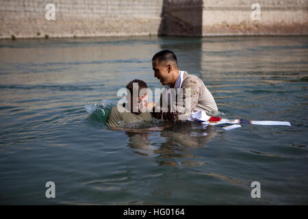 110828-M-EU691-047 SANGIN, Afghanistan (Aug. 28, 2011) Cpl. David Anglin, assigned to the Advisor Team, 1st Battalion, 5th Marines, Regimental Combat Team 8, is baptized by Navy Lt. David Kim, the battalion chaplain, at Forward Operating Base Jackson. (U.S. Marine Corps photo by Cpl. Logan W. Pierce/Released) US Navy 110828-M-EU691-047 Cpl. David Anglin, assigned to the Advisor Team, 1st Battalion, 5th Marines, Regimental Combat Team 8, is baptized by Na Stock Photo