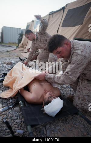 110908-M-EU691-012 SANGIN, Afghanistan (Sept. 8, 2011) Hospital Corpsman 2nd Class Richard Erfurth, assigned to Jump Platoon, 1st Battalion, 5th Marines, Regimental Combat Team 8, treats a casualty at Forward Operating Base Jackson. The Marines and Afghan Uniformed Policeman were struck by a suicide bomber using a vehicle-borne improvised explosive device while on a patrol. (U.S. Marine Corps photo by Cpl. Logan W. Pierce/Released) US Navy 110908-M-EU691-012 Hospital Corpsman 2nd Class Richard Erfurth, assigned to Jump Platoon, 1st Battalion, 5th Marines, Regimental Combat Te Stock Photo