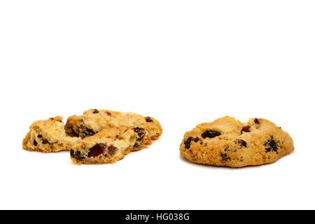 Two cookies with raisins broken into pieces isolated on white background. Stock Photo