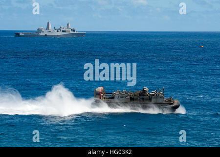 MARINE CORPS BASE HAWAII (July 30, 2016) A landing craft, air cushion passes amphibious transport dock ship USS San Diego (LPD 22) while conducting an amphibious assault exercise during Rim of the Pacific (RIMPAC) 2016. Twenty-six nations, more than 40 ships and submarines, more than 200 aircraft and 25,000 personnel are participating in RIMPAC from June 30 to Aug. 4, in and around the Hawaiian Islands and Southern California. The world's largest international maritime exercise, RIMPAC provides a unique training opportunity that helps participants foster and sustain the cooperative relationshi Stock Photo