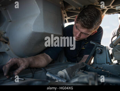 A fire controlman aboard USS Stout performs maintenance on the Phalanx close-in weapons system while the destroyer conducts naval operations in the U.S. 6th Fleet area as part of the Eisenhower Carrier Strike Group deployment. Stock Photo