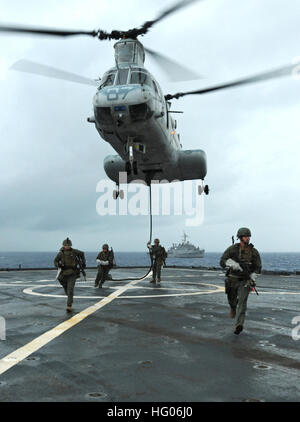 111004-N-MW330-253 PHILIPPINE SEA (Oct. 4, 2011) Marines assigned to the maritime raid force of the 31st Marine Expeditionary Unit (31st MEU) fast-rope from a CH-46E Sea Knight helicopter during a visit, board, search and seizure drill aboard the forward-deployed amphibious dock landing ship USS Germantown (LSD 42). Germantown is part of the Essex Amphibious Ready Group and is conducting operations in the western Pacific region. (U.S. Navy photo by Mass Communication Specialist 2nd Class Spencer Mickler/Released) US Navy 111004-N-MW330-253 Marines assigned to the maritime raid force of the 31s Stock Photo