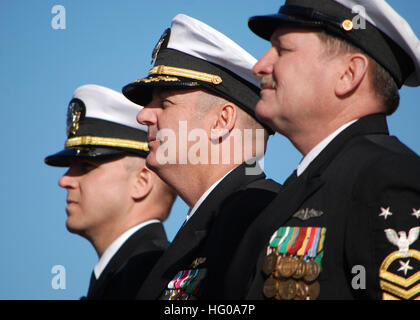 111203-N-AW324-098 GROTON, Conn. (Dec. 3, 2011) Lt. Cmdr. Daniel Reiss, left, executive officer of the Virginia-class attack submarine Pre-Commissioning Unit (PCU) Mississippi (SSN 782), Capt. John McGrath, commanding officer, and Master Chief Machinist's Mate (Submarines) William Stoiber, chief of the boat, listen to remarks during the boat’s christening ceremony. Mississippi is the ninth Virginia-class submarine and the fifth U.S. Navy ship to be named for the Magnolia State. (U.S. Navy photo by Mass Communication Specialist 1st Class Virginia K. Schaefer/Released) US Navy 111203-N-AW324-098 Stock Photo