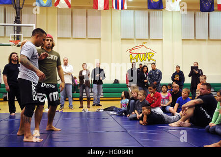 111214-N-RN782-235 SIGONELLA, Sicily (Dec. 14, 2011) Urijah 'The California Kid' Faber, former World Extreme Cage-fighting Featherweight champion, instructs an Ultimate Fighting Championship grappling and training seminar to service members and their family members at Naval Air Station Sigonella in the base gymnasium. Faber was on a nine-day tour, sponsored by Armed Forces Entertainment, to visit with service members and their family members. (U.S. Navy photo by Mass Communication Specialist Seaman Apprentice Brian Glunt/Released) US Navy 111214-N-RN782-235 Urijah Stock Photo