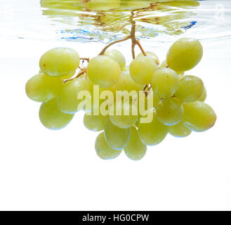 Grapes floating in the water on a white background Stock Photo