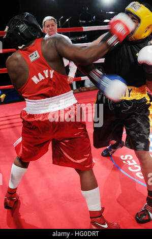 120131-N-ZZ999-718 CAMP PENDLETON, Calif. (Jan. 21, 2012) Hospitalman Brandon Wicker smashes a right hook into Army Sgt. Charles Blackwell in the preliminaries of the 2012 Armed Forces Boxing Champions. Wicker fights for the Navy Boxing Team in the 201lb weight class. Wicker lost to Blackwell 13-10 on the first day of preliminary fights. (U.S. Navy photo by Mass Communication Specialist 2nd Class Elliott Fabrizio/Released) US Navy 120131-N-ZZ999-718 Hospitalman Brandon Wicker smashes a right hook into Army Sgt. Charles Blackwell in the preliminaries of the 2012 Armed Stock Photo