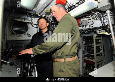 120212-N-KB563-083 PACIFIC OCEAN (Feb. 12, 2012) Chief Operations Specialist Barnett, right, gives Japan Maritime Self-Defense Force Rear Adm. Kitagawa Fumiyuki, commander of Escort Flotilla Three, a tour of Landing Craft Utility (LCU) 1632 aboard the amphibious assault ship USS Peleliu (LHA 5). Peleliu is participating in Exercise Iron Fist 2012, a training exercise between U.S. Marines and the Japan Ground Self-Defense Force designed to increase interoperability and amphibious capabilities throughout the U.S. 3rd and 7th Fleet areas of responsibility. (U.S. Navy photo by Mass Communication S Stock Photo