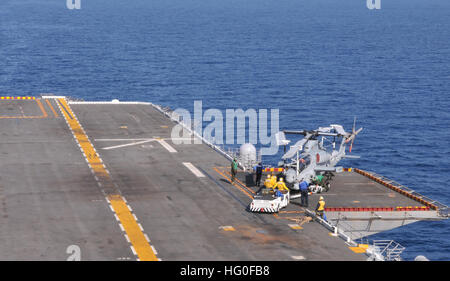 U.S. sailors use an aircraft tow tractor to move an AH-1Z Viper helicopter on the port side elevator aboard the amphibious assault ship USS Peleliu (LHA 5) under way in the Pacific Ocean May 31, 2012. Peleliu and her amphibious ready group are participating in a combined amphibious squadron and U.S. Marine Corps Marine expeditionary unit integrated training. (U.S. Navy photo by Mass Communication Specialist Seaman Derek Stroop/Released) USS Peleliu 120531-N-HF252-052 Stock Photo