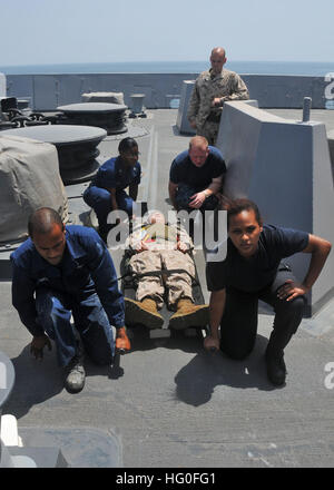 120717-N-NN926-062 ARABIAN SEA (July 17, 2012) Sailors prepare to transport a U.S. Marine with a simulated injury to medical during a training evolution aboard the amphibious transport dock ship USS New York (LPD 21). New York is part of the Iwo Jima Amphibious Ready Group with the embarked 24th Marine Expeditionary Unit and is deployed supporting maritime security operations and theater security cooperation efforts in the U.S. 5th Fleet area of responsibility. (U.S. Navy photo by Mass Communication Specialist 2nd Class Zane Ecklund/Released) USS New York action 120717-N-NN926-062 Stock Photo