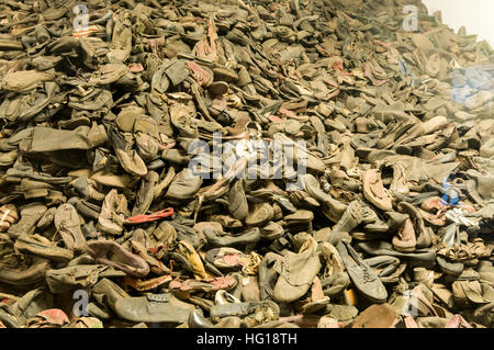 In one of the brick accommodation blocks (all turned into museums) with a  large window display of shoes snatched from the prisoners at Auschwitz Birk Stock Photo