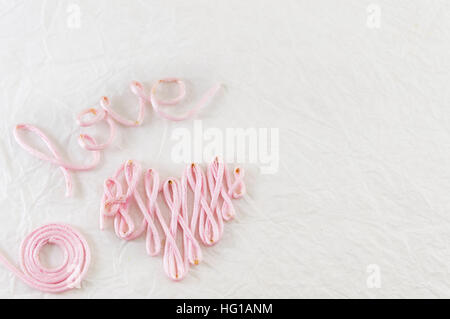 Word love made out of pink sewing thread Stock Photo