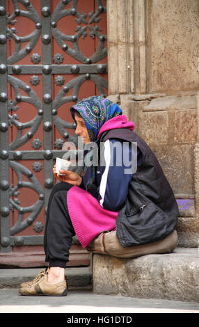 Woman begging outside Santa Maria del Mar church in Barcelona Stock Photo