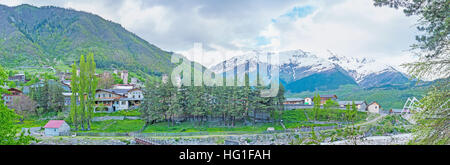 The green banks of Mestiachala river with the snowy Banguriani mountain range on the background, Mestia, Upper Svaneti, Georgia.