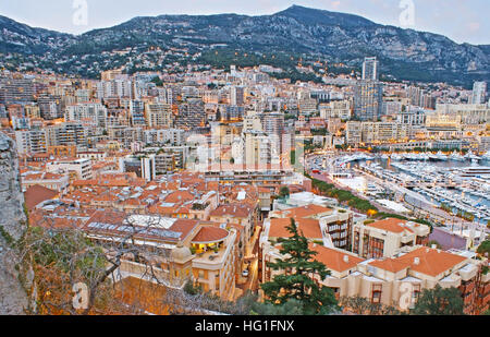 The view from the Rock of Monaco-Ville on the roofs of La Condamine ward and high-rises of Monte Carlo, located at the mountain foot, Monaco. Stock Photo