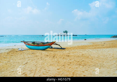 The Seenigama Muhudu Viharaya Buddhist Temple on the tiny island is seen from the local beach, Hikkaduwa, Sri Lanka. Stock Photo