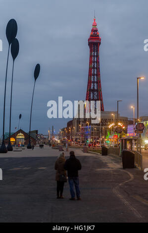 A couple looking at Blackpool Tower In Blackpool, Lancashire, UK at night. Stock Photo