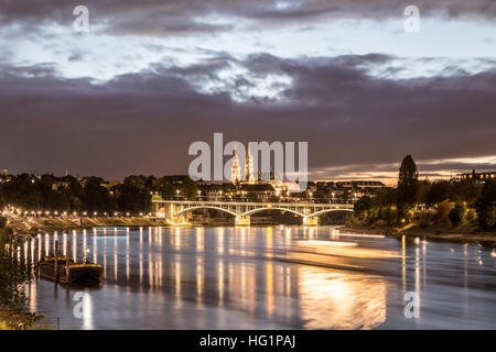 Basel, Switzerland - October 20, 2016: Night view of the Rhine River with the illuminated Basel Minster Stock Photo