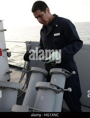 140225-N-HB951-021 ATLANIC OCEAN (Feb. 25, 2014) –Cryptologic Technician (Collection) 3rd Class Bryan Chavarry, from Miami, performs a regularly scheduled maintenance on a chaff canister aboard the amphibious transport dock ship USS Mesa Verde (LPD 19). Mesa Verde Sailors and Marines assigned to 22nd Marine Expeditionary Unit are deployed supporting maritime security operations, providing crisis response capability, increasing theater security cooperation and a forward naval presence in the U.S. 5th and 6th Fleet areas of responsibility. (U.S. Navy photo by Seaman Phylicia A. Hanson/Released)  Stock Photo