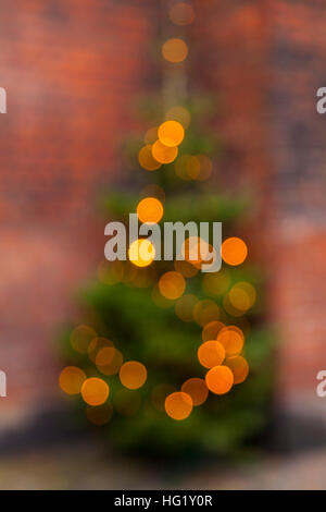 Image of outdoor christmas tree with lights. Blurry background. Stock Photo