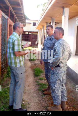 Lab administrator Dr. Hale confers with U.S. Army Africa’s Command surgeon Col. James Czarnik and U.S. Embassy Monrovia senior defense official Col. Mitchell about the process of extracting and testing for Ebola. U.S. Agency for International Development is the lead U.S. government organization for Operation United Assistance. U.S. Africa Command is supporting the effort by providing command and control, logistics, training and engineering assets to contain the Ebola virus outbreak in West African nations. (U.S. Army Africa photo by Cmdr. Peter Niles/Released) USARAF team helping fight Ebola o Stock Photo