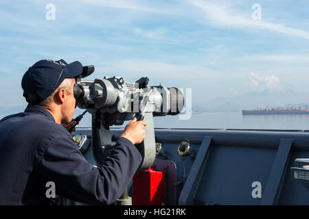 Lt. David Smith, from Nacogdoches, Texas, scans for surface contacts through the ‘big eyes’ binoculars on the bridge wing of the amphibious dock landing ship USS Germantown (LSD 42) as the ship prepares to arrive in Subic Bay, Philippines for Amphibious Landing Exercise (PHIBLEX). PHIBLEX is an annual bilateral training exercise conducted with the Armed Forces of the Philippines. Germantown is part of the Peleliu Expeditionary Strike Group, commanded by Rear Adm. Hugh Wetherald, and is conducting joint forces exercises in the U.S. 7th Fleet area of responsibility.  (U.S. Navy Photo by Mass Com Stock Photo