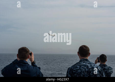 Sailors watch as a Portuguese P-3 Orion flies over the Military Sealift Command’s joint high-speed vessel USNS Spearhead (JHSV 1), Jan. 19, 2015. Spearhead is on a scheduled deployment to the U.S. 6th Fleet area of operations to support the international collaborative capacity-building program Africa Partnership Station. (U.S. Navy photo by Mass Communication Specialist 2nd Class Kenan O’Connor/Released) USS Spearhead operations 150119-N-JP249-041 Stock Photo