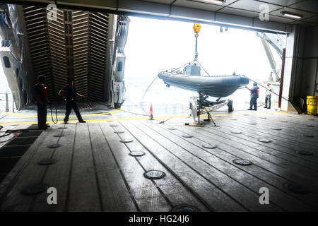 150219-N-RB579-020 ATLANTIC OCEAN (Feb. 19, 2015) Civil service mariners and Sailors prepare to launch a small rigid hull inflatable boat as part of Africa Maritime Law Enforcement Partnership operations aboard the Military Sealift Command's joint high-speed vessel USNS Spearhead (JHSV 1) Feb. 19, 2015. Spearhead is on a scheduled deployment to the U.S. 6th Fleet area of operations in support of the international collaborative capacity-building program Africa Partnership Station. (U.S. Navy photo by Mass Communication Specialist 1st Class Joshua Davies/Released) USNS Spearhead (JHSV 1) 150219- Stock Photo