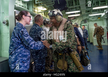 150227-N-UF697-215 SOUTH CHINA SEA (Feb. 27, 2015) Capt. Heidi Agle, Commander Amphibious Squadron Eleven, shakes hands with Lt. Col. Abdul Jalal Zaidi bin Abdul Majid, Malaysian Chief of Operations, Joint Task Force 2, during a visit to the forward-deployed amphibious assault ship USS Bonhomme Richard (LHD 6). Bonhomme Richard is in Malaysia for a scheduled port visit and is the lead ship of the Bonhomme Richard Amphibious Ready Group, comprised of USS Ashland (LSD 48), USS Germantown (LSD 42) and, the newest member, USS Green Bay (LPD 20). The purpose of the port call in Malaysia is to conti Stock Photo
