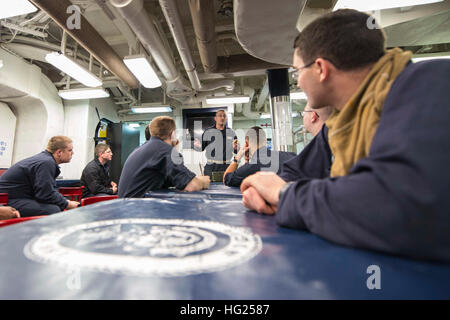 150310-N-VC236-033  ATLANTIC OCEAN (March 10, 2015) - Chief Damage Controlman Christopher Kujat gives training on how to respond to a chemical, biological or radiological (CBR) threat following a general quarters drill aboard the Arleigh Burke-class guided-missile destroyer USS Farragut (DDG 99). Farragut is underway as part of the USS Theodore Roosevelt Carrier Strike Group to support maritime security operations and theater security cooperation efforts in the U.S. 5th and 6th Fleet areas of responsibility. (U.S. Navy Photo by Mass Communication Specialist 3rd Class Jackie Hart/Released) USS  Stock Photo