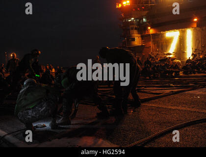 150310-N-VH385-028  NORFOLK (March 10, 2015) – Sailors aboard the Nimitz-class aircraft carrier USS Theodore Roosevelt (CVN 71) prepare to raised the aircraft barricade during a flight deck drill. TR  holds flight deck drills to train Sailors on proper procedures during emergency situations. TR and its Sailors will conduct operations in the 5th, 6th and 7th Fleet areas of responsibility supporting maritime security operations in international waters around the world. (U.S. Navy Photo by Mass Communication Specialist Seaman Wyatt L. Anthony/Released) USS Theodore Roosevelt operations 150310-N-V Stock Photo