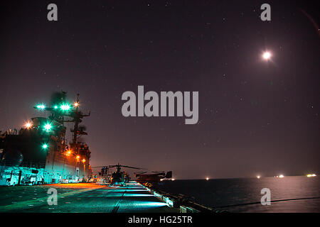 150326-N-GG858-018 WATERS EAST OF THE KOREAN PENINSULA (March 26, 2015) – Forward-deployed amphibious assault ship USS Bonhomme Richard (LHD 6) steams through the East China Sea at night. Bonhomme Richard is the lead ship of the Bonhomme Richard Amphibious Ready Group (ARG) and, along with the embarked 31st Marine Expeditionary Unit (MEU), is currently underway in the 7th Fleet Area of Operations. (U.S Navy photo by Mass Communication Specialist 2nd Class Matthew Dickinson/ Released) USS Bonhomme Richard operations 150326-N-GG858-018 Stock Photo