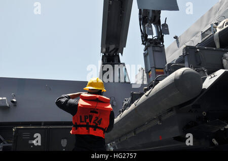 150509-N-GG458-024 ATLANTIC OCEAN (May 9, 2015) Boatswain's Mate 2nd Class Anthony Richardson directs a rigid-hull inflatable boat (RIB) as it is removed from the boat deck of the amphibious transport dock ship USS Arlington (LPD 24) and lowered into the water. Arlington is underway as part of the Amphibious Squadron (PHIBRON) 4 and the 26th Marine Expeditionary Unit (MEU) for PHIBRON-MEU Integrated Training (PMINT) in preparation for the ship's first operational deployment. (U.S. Navy photo by Mass Communication Specialist 2nd Class Stevie Tate/Released) USS Arlington operations 150509-N-GG45 Stock Photo