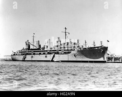 USS Sierra (AD-18) moored to buoys with the masts visible of five destroyers moored to her port side. USS De Haven (DD-727) and USS Collett (DD-730) are both visible beyond Sierra's bow. The place and date are unknown. However, judging from the small wartime hull numbers on these ships, their World War II vintage radars and their post-war haze gray paint schemes, the picture was taken probably about 1946 or 1947. It was certainly taken prior to June 1949 when Sierra transfered to the Atlantic Fleet while De Haven and Collett continued their Pacific Fleet service.  Official U.S. Navy Photograph Stock Photo