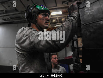 151029-N-PG340-080  SOUTH CHINA SEA (Oct. 29, 2015) –  Aviation Machinist’s Mate Airman Corey McGinley, from Westerville, Ohio, conducts an 84-day inspection on a variable exhaust nozzle in the hangar bay aboard the aircraft carrier USS Theodore Roosevelt (CVN 71). Theodore Roosevelt is operating in the U.S. 7th Fleet area of operations as part of a worldwide deployment en route to its new homeport in San Diego to complete a three-carrier homeport shift. (U.S. Navy photo by Mass Communication Specialist 3rd Class Stephane Belcher/Released) USS Theodore Roosevelt operations 151029-N-PG340-080 Stock Photo