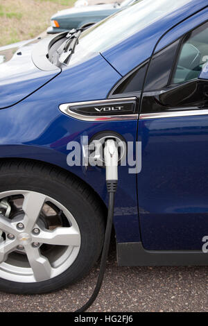 Electric port of a Chevy Volt car being recharged in Great River Energy headquarters parking lot. Maple Grove Minnesota MN USA Stock Photo