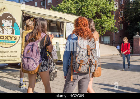 Student buying food from food trucks in Harvard Square, Harvard Square, Cambridge, Massachusetts Stock Photo