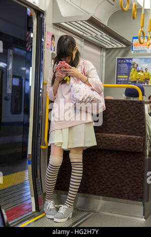 Unidentified woman at Kyoto subway in Japan. Kyoto Municipal Subway began operation at 1981 and have length of 31.2 km Stock Photo