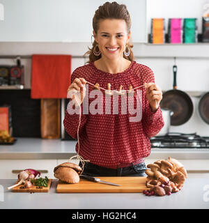 Young housewife drying mushrooms Stock Photo