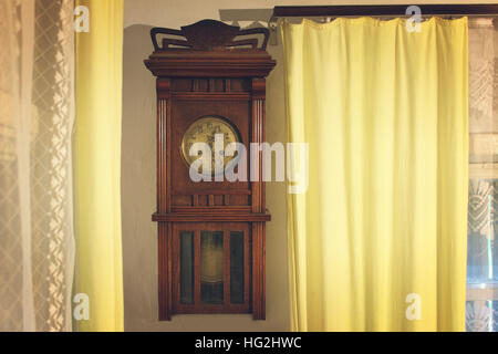 The vintage brown wooden wall worn clock Stock Photo