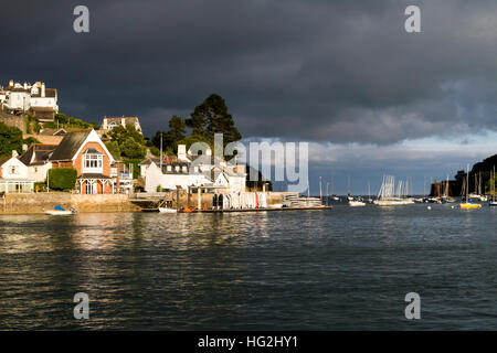 Kingswear under Dark Skies, View from the River Dart looking Towards the Sea and Dartmouth Castle, Devon. Stock Photo