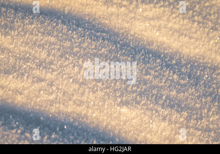 Snow, sun and shadows makes the snow blue and pink Stock Photo