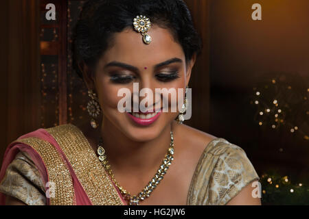 Beautiful young woman in traditional dress and jewelry Stock Photo