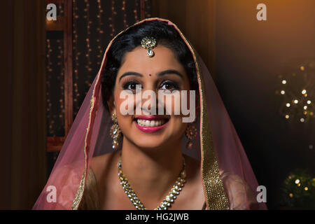 Close-up portrait of  young woman in traditional dress and jewelry Stock Photo