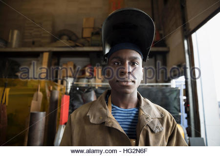 Portrait confident welder wearing protective workwear in workshop